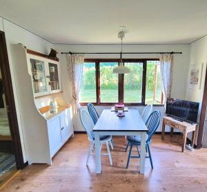 a kitchen and dining room with a table and chairs at Ferienhaus Stensjö in Holmsjö