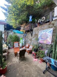 a patio with couches and chairs and plants at La Mancha Art Hostel - Cerro Alegre - Valparaiso in Valparaíso