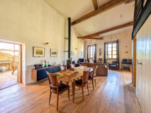 a large living room with a table and chairs at Maison Rives - Village du Livre de Montolieu in Montolieu +43 photos