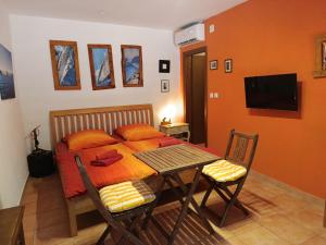 a bedroom with a bed and a table and chairs at Appartement Melchior - Turm Krk in Sveti Vid-Miholjice +9 photos