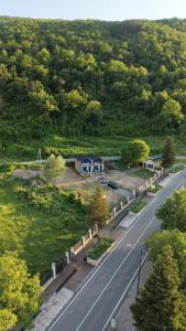 a road with a house on the side of a hill at Racha Mountain Shadow in Ambrolauri +3 photos