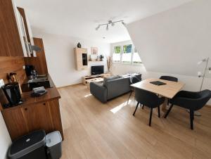 a living room with a table and a couch at Wald Villa Üssbach in Alf +59 photos