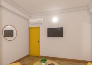 a room with a yellow door and a mirror at Bloom Hotel Chennai Central in Chennai