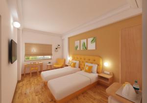 a hotel room with a bed and a desk at Bloom Hotel Chennai Central in Chennai