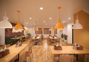 a restaurant with wooden tables and chairs and pendant lights at Bloom Hotel Chennai Central in Chennai
