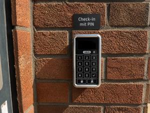 a cell phone is plugged into a brick wall at Hotel am Seehafen in Hamburg +21 photos