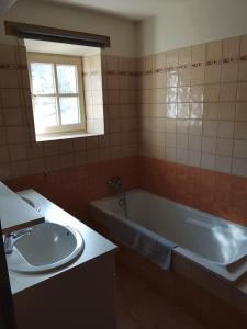 a bathroom with a tub and a sink at La Maison du Bonheur in Jaujac +24 photos
