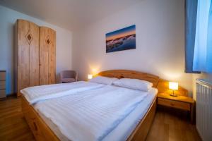 a bedroom with a large bed with two pillows at Apartment Riviera 503-8 Lipno Home in Lipno nad Vltavou