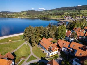 an aerial view of a house next to a lake at Apartment Riviera 503-8 Lipno Home in Lipno nad Vltavou