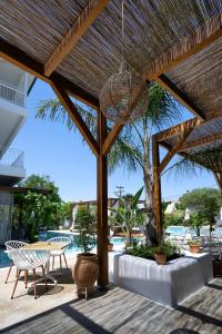 a patio with a table and chairs and a pool at Agorastos Luxury Living in Platamonas
