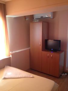 a bedroom with a bed and a tv on a cabinet at Casa Mario in 2 Mai