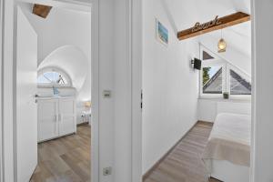a room with a bed and a window at Ferienhaus Malebisa in Loddin