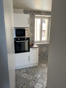 a kitchen with a stove and a microwave at L'estive de Doris in Remollon +18 photos