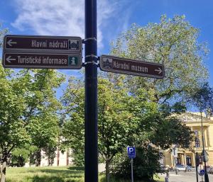 two street signs on a pole in front of a building at Esplanade Hotel Prague in Prague
