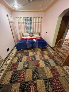 a bedroom with a bed and a rug at Urban Den Hostel in Srinagar