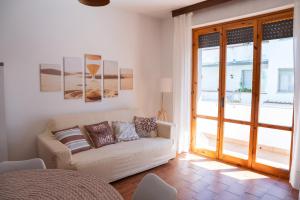 a living room with a couch and a window at Kronos House in Torre del Lago Puccini