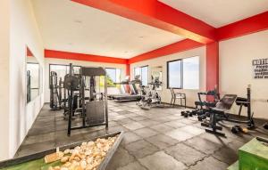 a gym with several treadmills and exercise equipment at ESEKK Ochi in Ocho Rios
