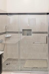 a shower with a glass door in a bathroom at ESEKK Ochi in Ocho Rios +21 photos