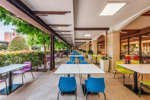 a row of tables and chairs in a restaurant at Premier Fort Beach Hotel in Sveti Vlas