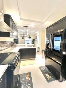 a kitchen with black cabinets and a black appliances at ESEKK Ochi in Ocho Rios