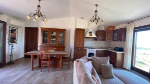 a living room with a couch and a table at Stazzo gallurese Li Nibbareddhi in Aglientu