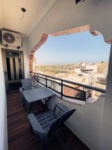 a balcony with two chairs and a table and a window at Hotel Résidence Awa Plazza 2 in Dakar