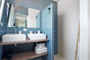 a bathroom with two sinks and a mirror at Chambres D'hôtes Authentique Pornic in Pornic