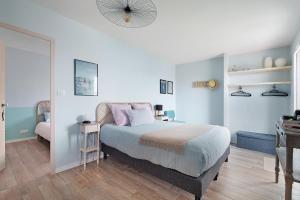a bedroom with a bed with pink pillows and a desk at Chambres D'hôtes Authentique Pornic in Pornic