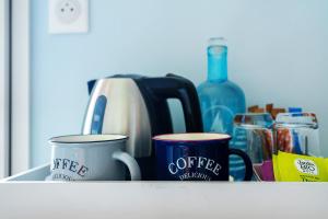 two coffee mugs are sitting on a counter at Chambres D'hôtes Authentique Pornic in Pornic