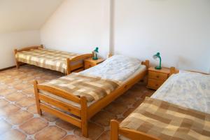 a bedroom with two beds and two night stands at Agroturystyka Nad Hańcza in Błaskowizna
