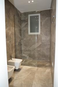 a bathroom with a shower and a toilet and a sink at Vila Gabriel in Shkodër +29 photos