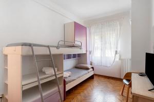 a small room with a bunk bed and a desk at La Rosa Blu Vacation Home in Sanremo