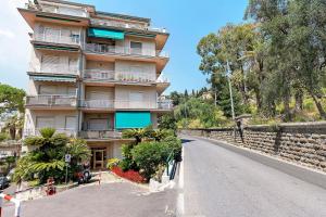 a building on the side of a road at La Rosa Blu Vacation Home in Sanremo