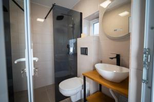 a bathroom with a toilet and a sink and a shower at Summer Vibe Costinesti in Costinesti +61 photos