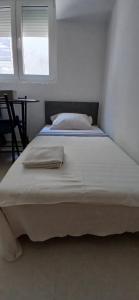 two beds in a white room with a window at Apartman Vuk in Budva