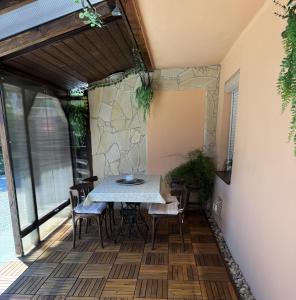 a dining room with a table and chairs on a patio at GaLiBa Vendégház in Jenő