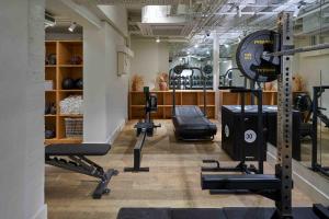 a gym with treadmills and weights in a room at Bermonds Locke, Tower Bridge in London +16 photos