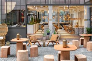 a lobby with tables and chairs in a building at Bermonds Locke, Tower Bridge in London