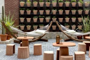 two hammocks in a patio with potted plants at Bermonds Locke, Tower Bridge in London