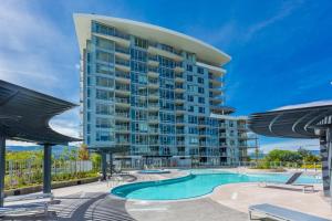 a large apartment building with a swimming pool at Beach Lake Resort in Kelowna