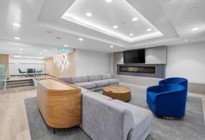 a living room with a couch and blue chairs at Beach Lake Resort in Kelowna
