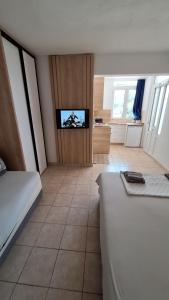 a bedroom with a bed and a flat screen tv at rašo in Pržno