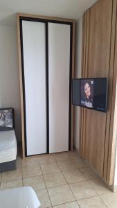 a room with a sliding door with a flat screen tv at rašo in Pržno