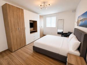 a bedroom with a bed and a television in it at Il Kenn ta Zeppi - Apartment 4 in Qala