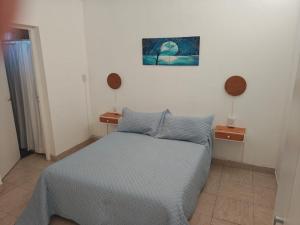 a bedroom with a bed and two night stands at La Esquina de Norma in General Villegas +4 photos