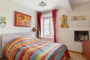 a bedroom with a bed and a window at Lacelledort in La Celle-Saint-Avant