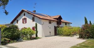 a large white house with a driveway at Abaca Colors in Saint-Martin-de-Seignanx