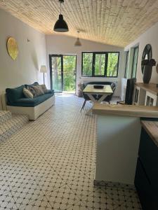 a living room with a couch and a table at Acasa la Coana Mare in Bălăneşti