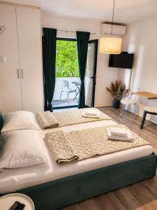 a large bed with two towels on it in a bedroom at Apartment Luka in Tučepi