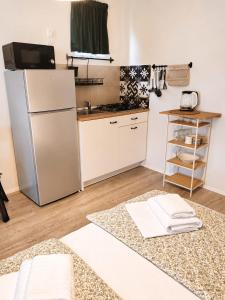 a kitchen with a refrigerator and a kitchen rug at Apartment Luka in Tučepi